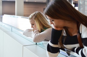 Lauren Gerrish and Geneva Mooradian look over the balcony at the Ochs-Sulzberger Great Hall of News.